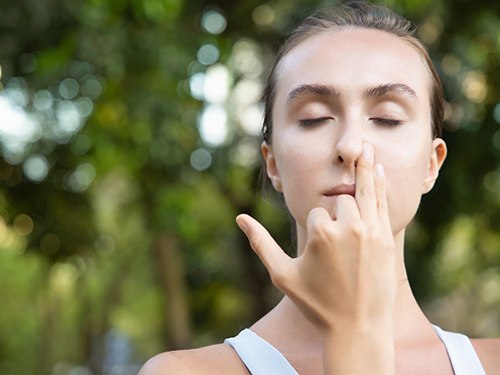 woman breathing through one nostril 