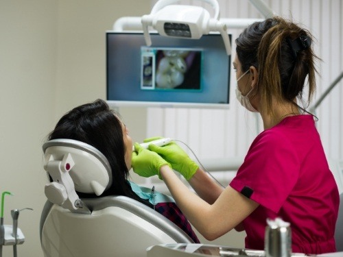 Dentist using intraoral camera to capture smile images