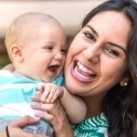 Mother holding baby after tongue tie treatment